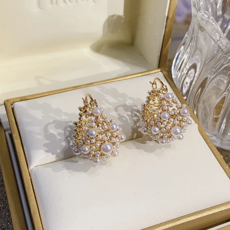 Gold women's earrings with flower basket design and small rice-shaped beads