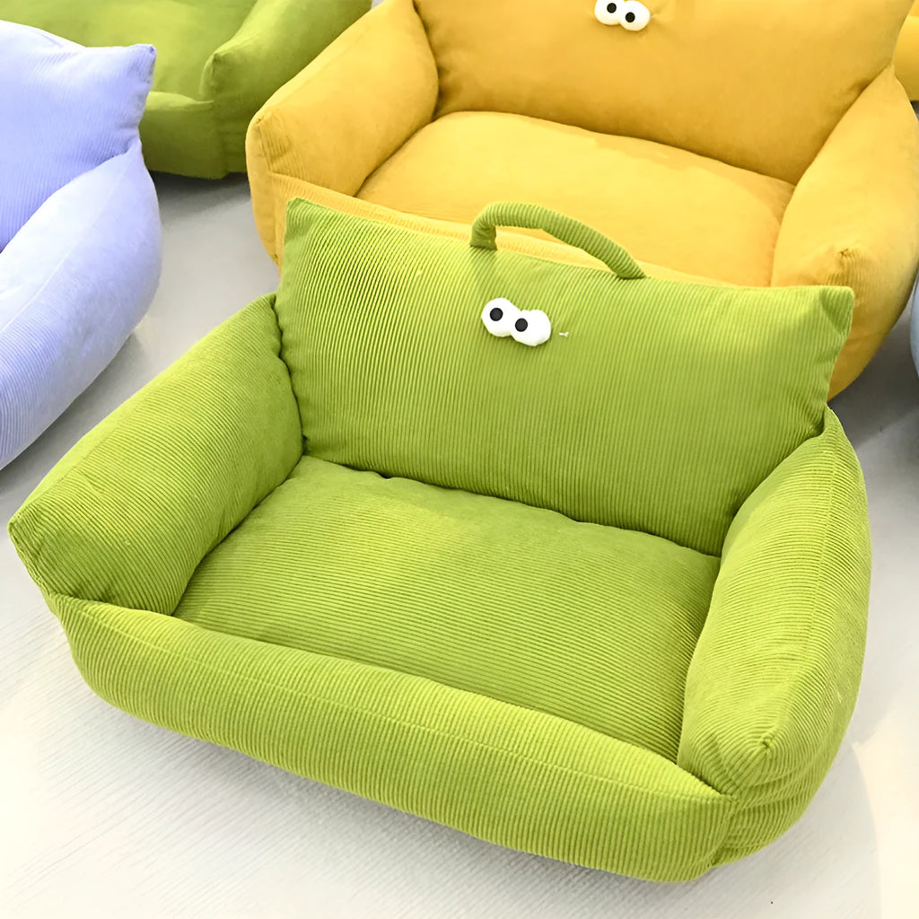 Blue cartoon big eye pet sofa kennel bed for small dog on a wooden floor.