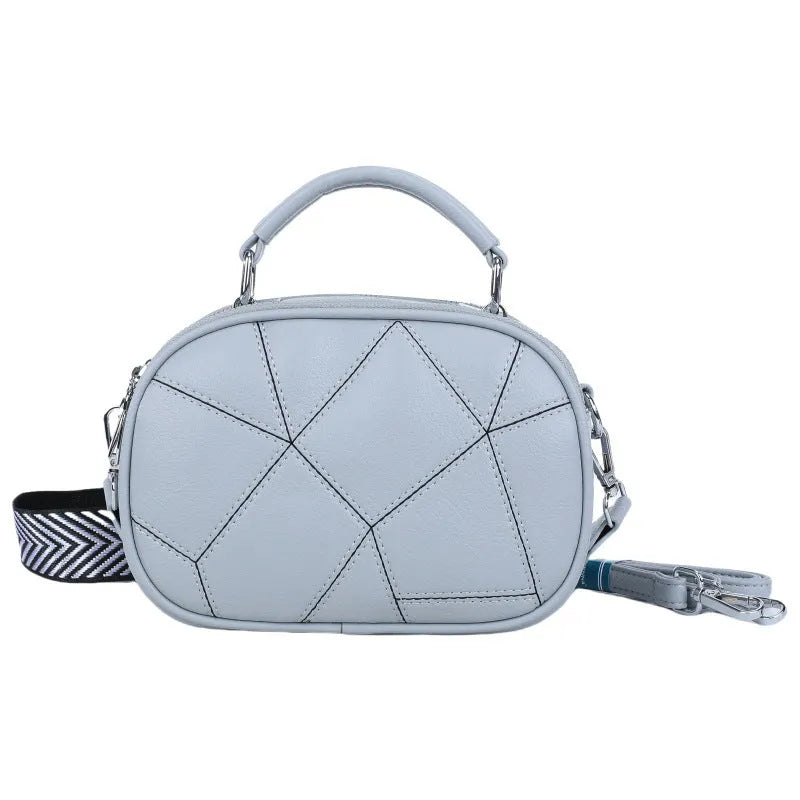 Small round patchwork bag in PU with visible stitching details, shown in beige colour