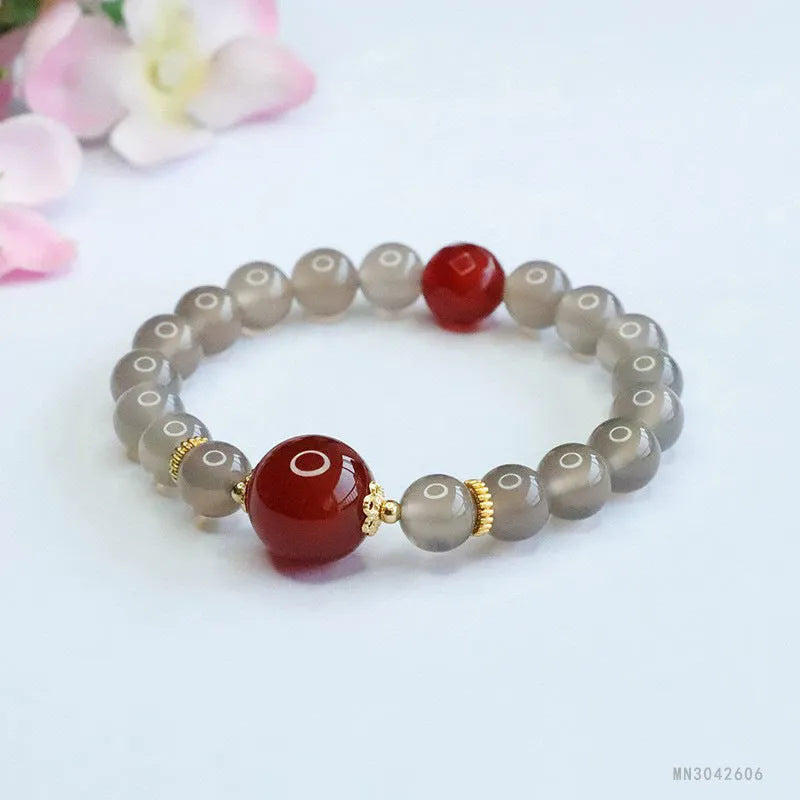 Smoky purple and red agate bracelet with 8mm geometric beads on a white background.