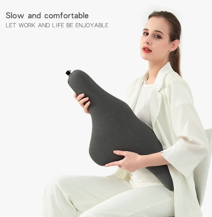 Dark grey memory foam car neck pillow resting on a car seat headrest.