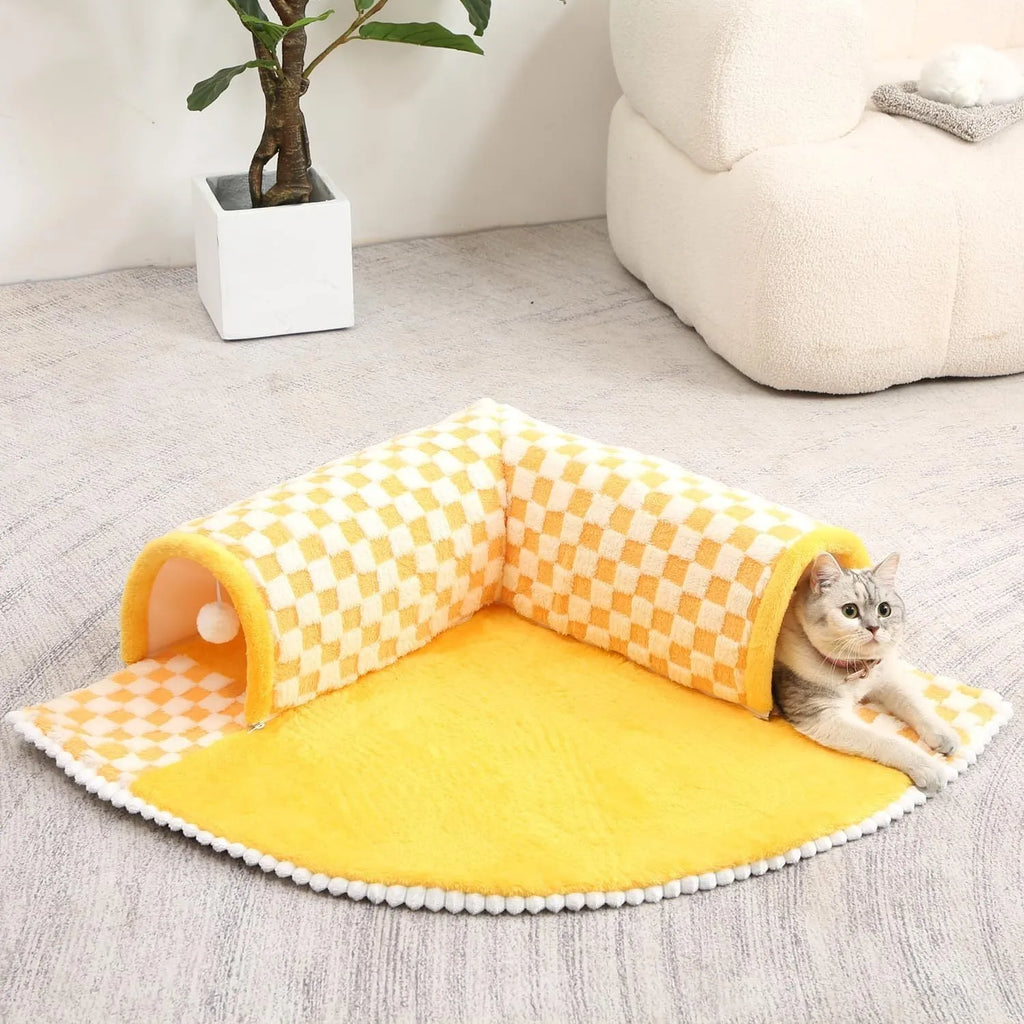 XL fan-shaped plush pet bed with a tunnel, in a plaid coffee colour, on a wooden floor.