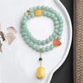 Close-up of a double-layer women's bracelet with green jade round beads and honey-coloured beeswax barrel beads.