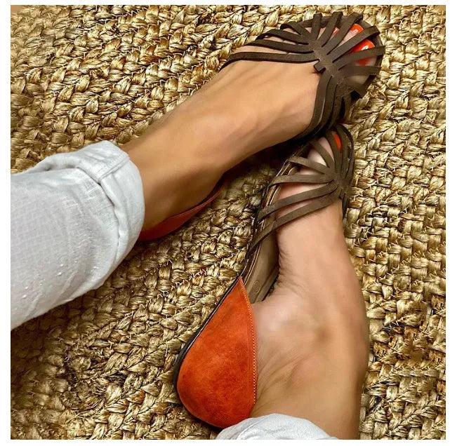 Women's dark brown leopard print flat sandals with a square buckle and herringbone toe detail.