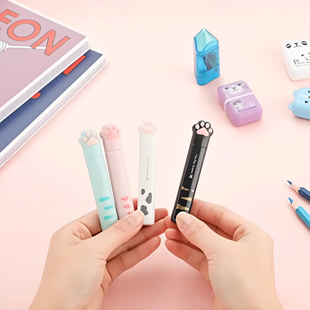 Small folding scissors with cat paw handles in pink, white, black, and blue colour options.