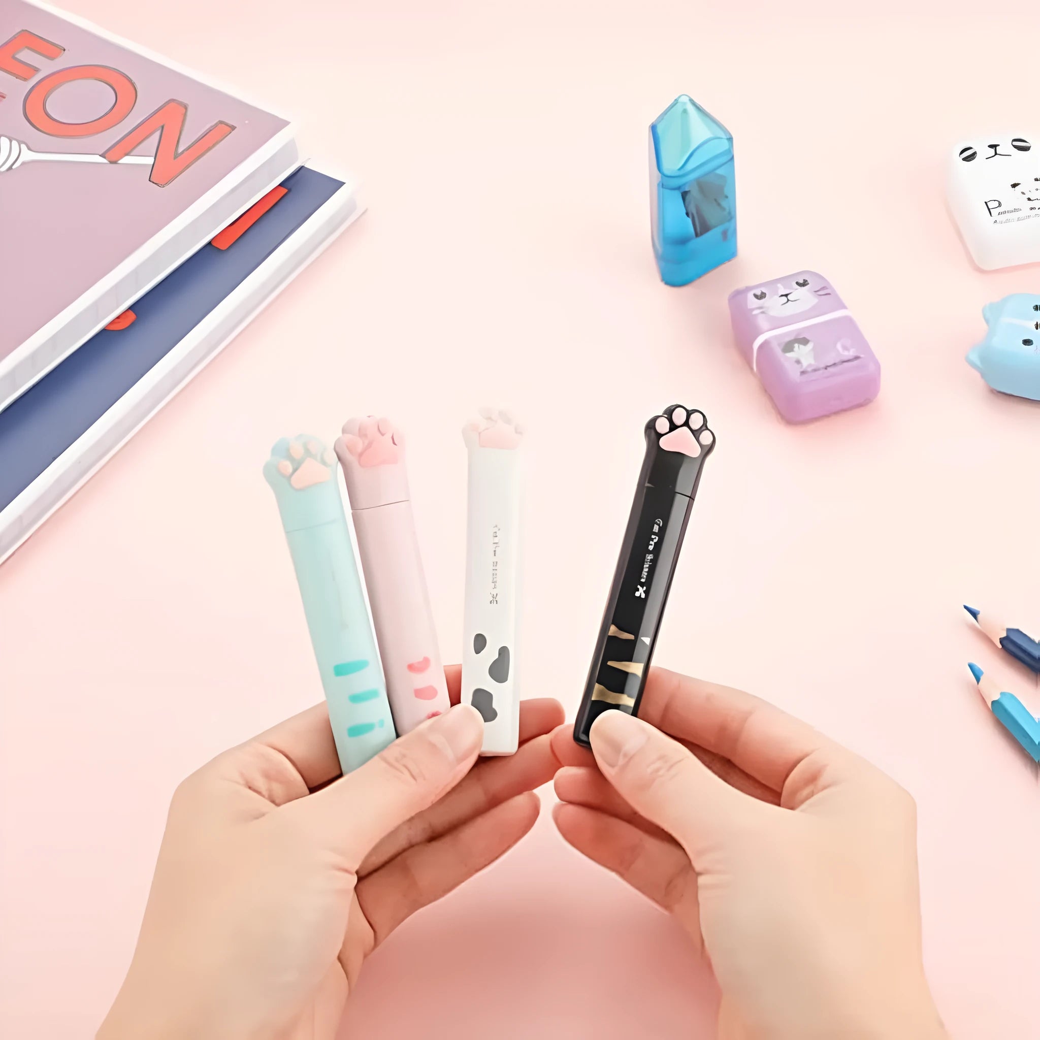 Small folding scissors with cat paw handles in pink, white, black, and blue colour options.