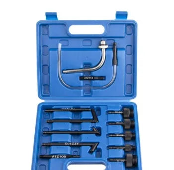 A 13-piece automatic transmission oil refuelling kit with a manual pump, hoses, and connectors laid out.
