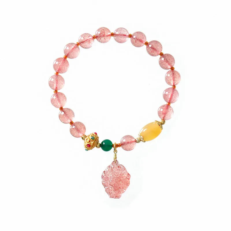 Close-up of a women's crystal beaded bracelet with a nine tail fox charm on a model's wrist.