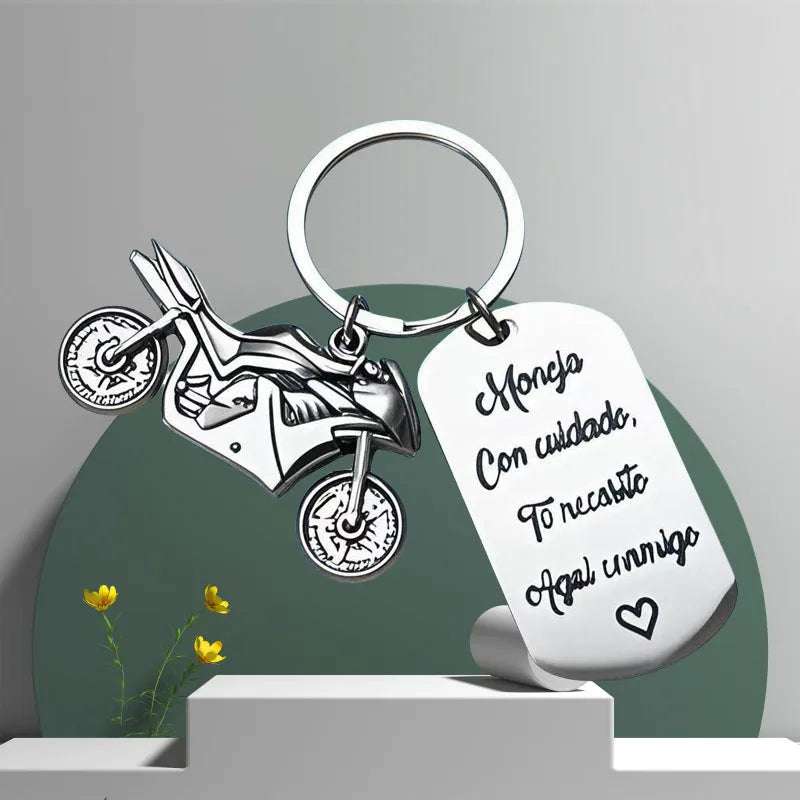 Stainless steel motorcycle keychain with minimalist design in a flannel gift bag.