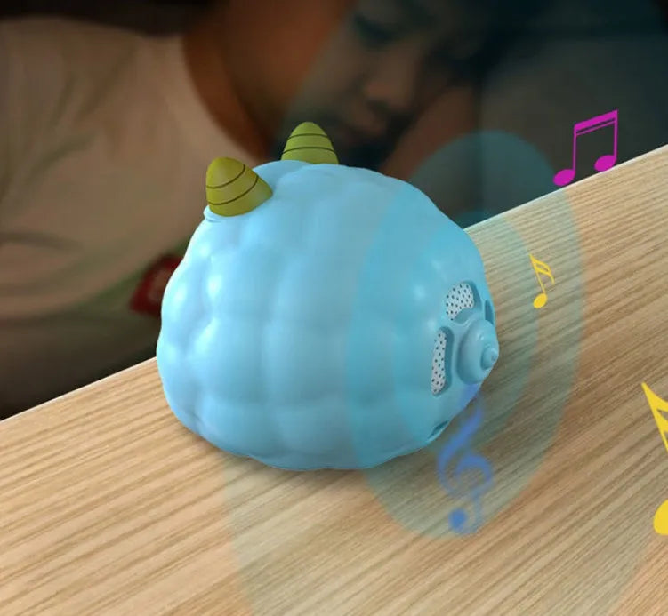 Smart alarm clock with silicone shell, luminous display, featuring voice and motion sensor controls.