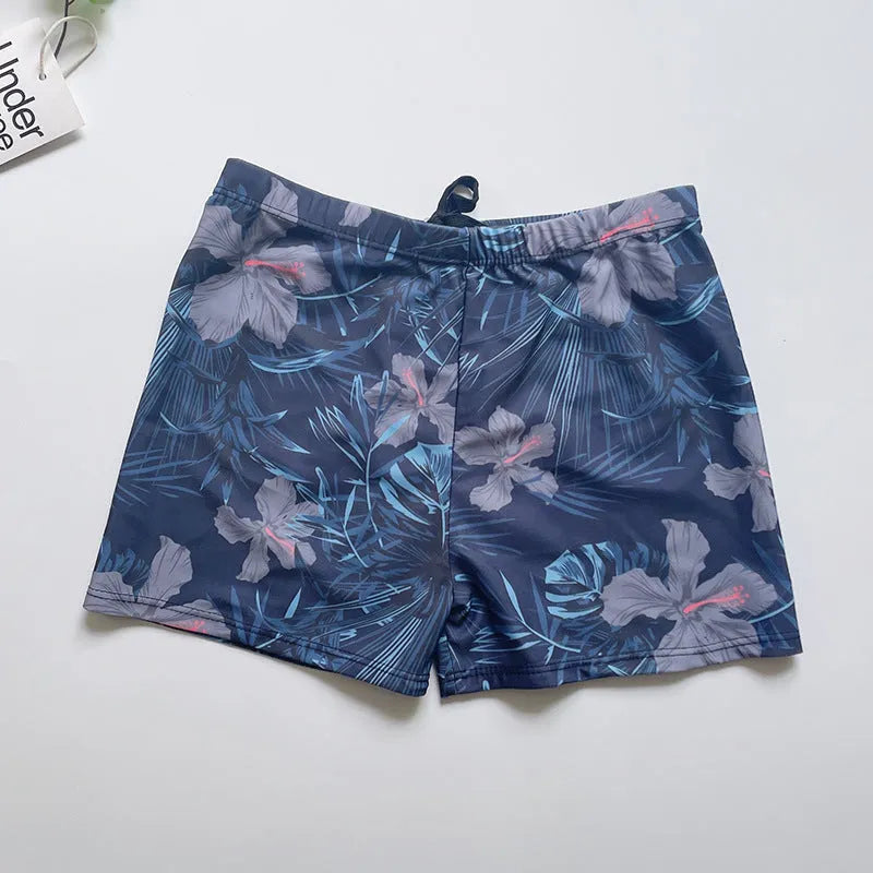 Men's loose fit anti-embarrassment swimming trunks in dark blue background large flower pattern, polyester fabric
