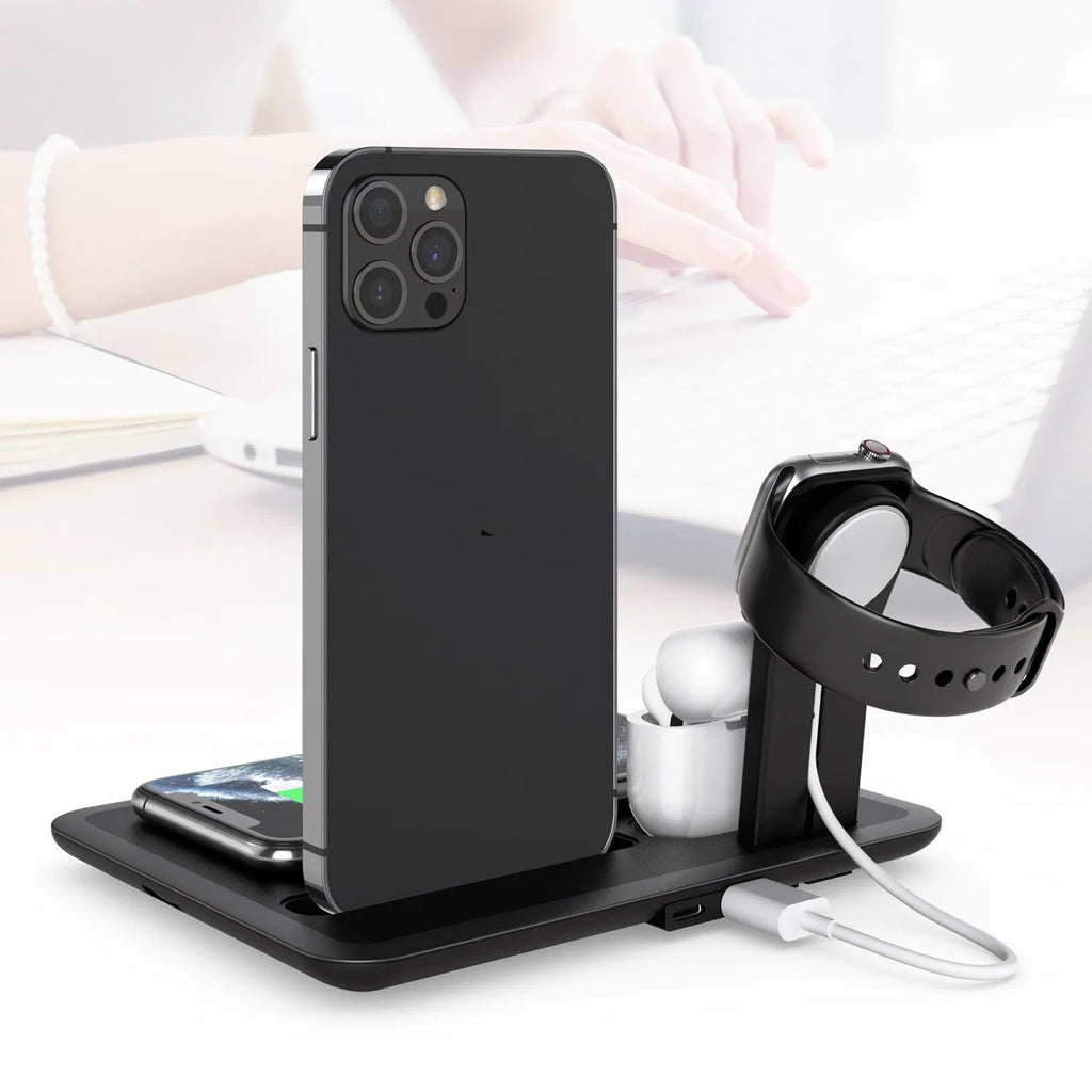 Black desktop wireless charging station with phone on pad, watch and headphone cables plugged in.