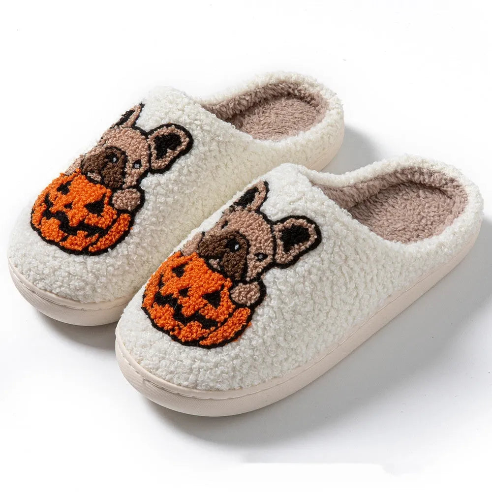 Black plush Halloween slippers with pumpkin print and a thick, textured TPR rubber sole.
