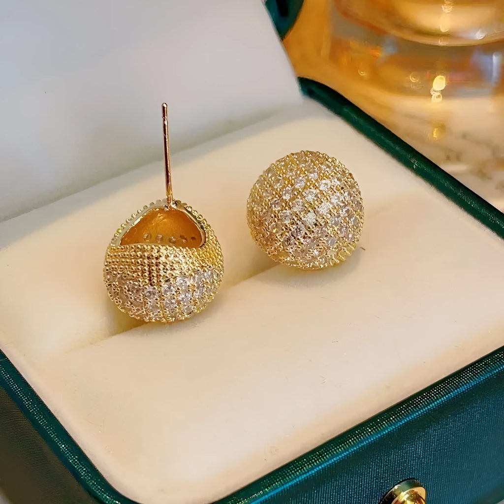 Women's drop-shaped clip earrings with full diamond elements and golden beans detailing