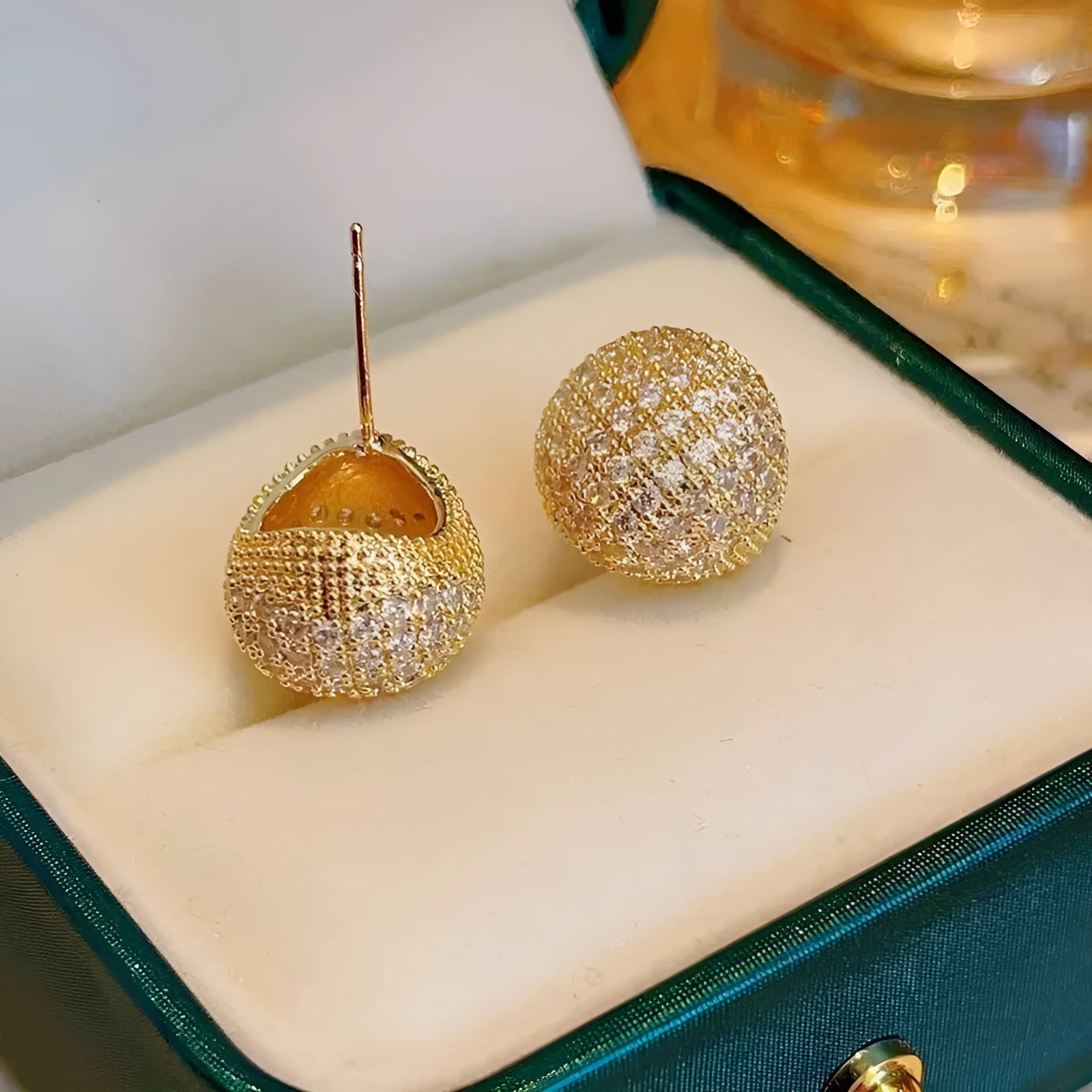 Women's drop-shaped clip earrings with full diamond elements and golden beans detailing