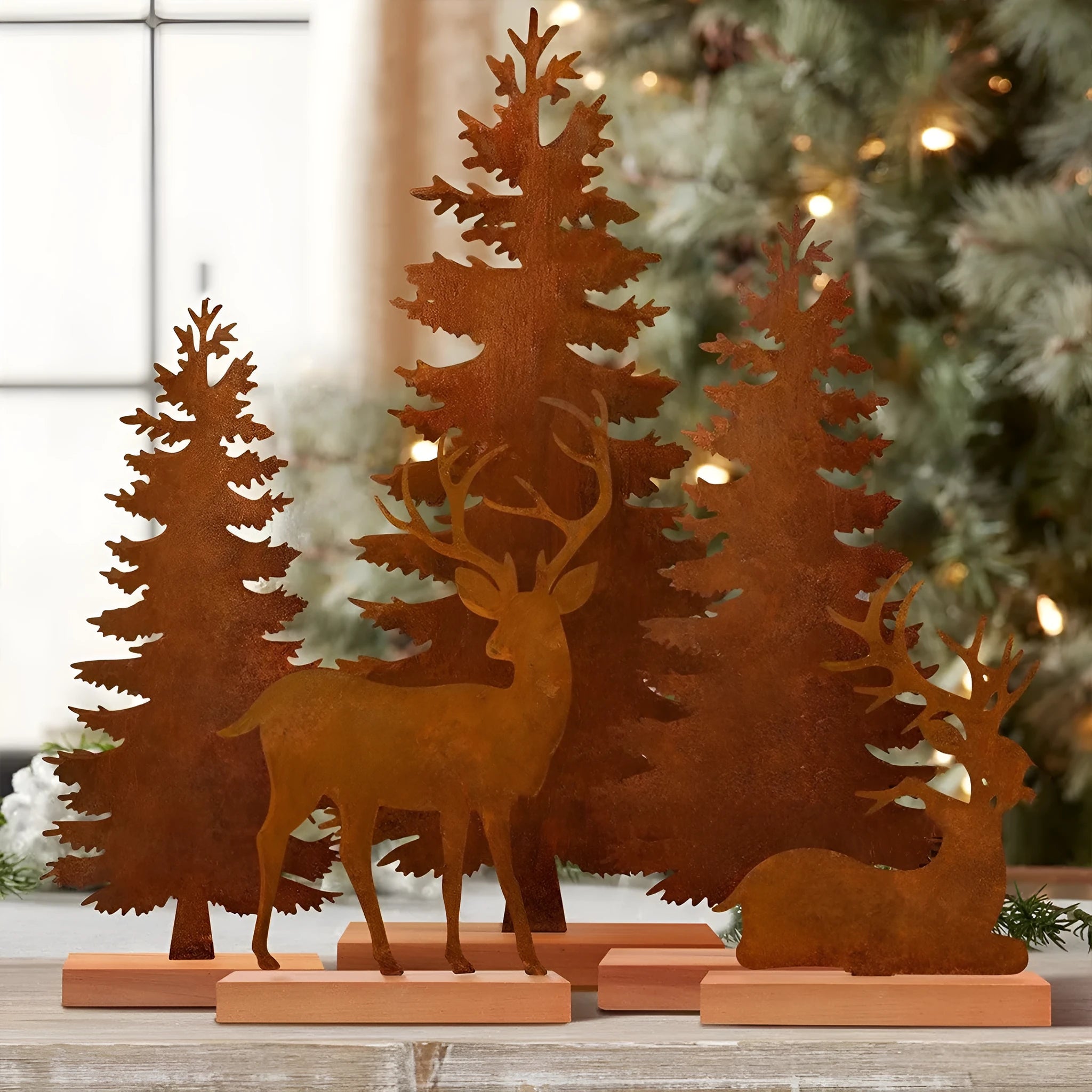 Three rusty metal elk Christmas tree ornaments with American-style design on green branches