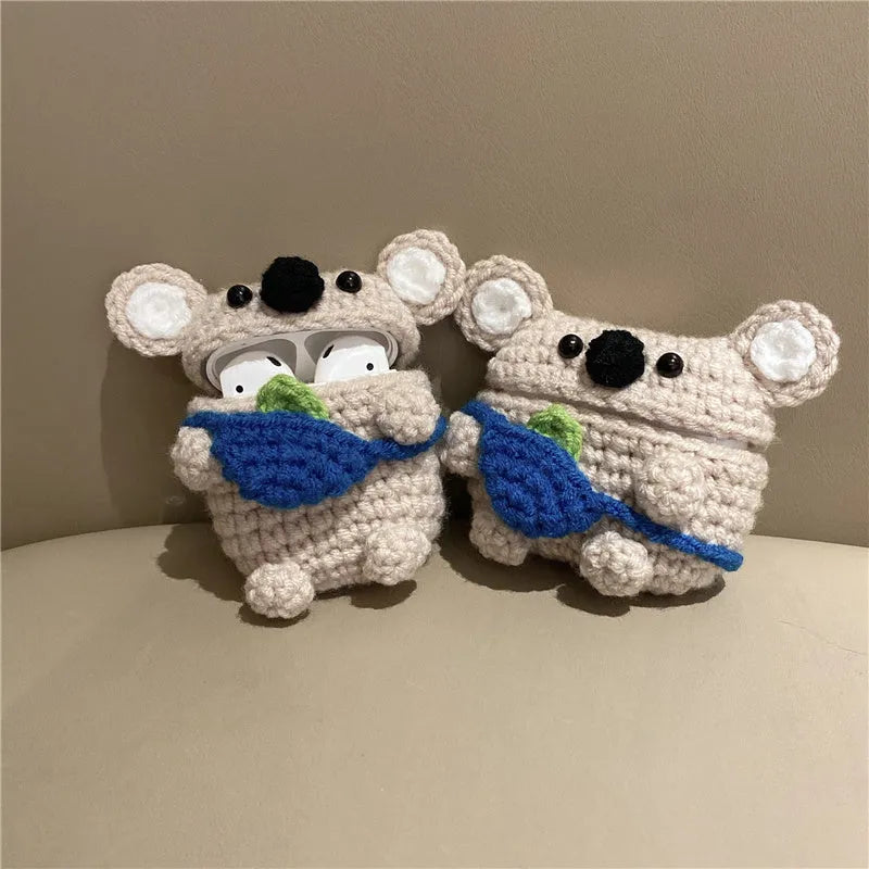 Handmade knitted koala bear backpack design cover on an AirPods case.
