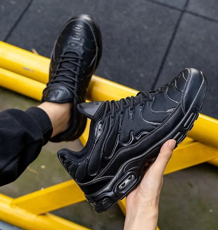 Black leather low-top safety sneakers with non-slip outsole, anti-smash and anti-scratch protection, available in sizes 41-47.