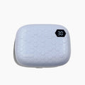 Pearl white automatic ultrasonic flushing instrument for cleaning glasses on a table.