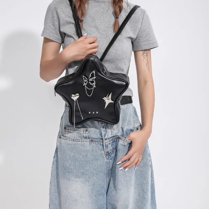 Black women's PU leather backpack with a silver metal butterfly star pendant, chain details, and an external pocket.