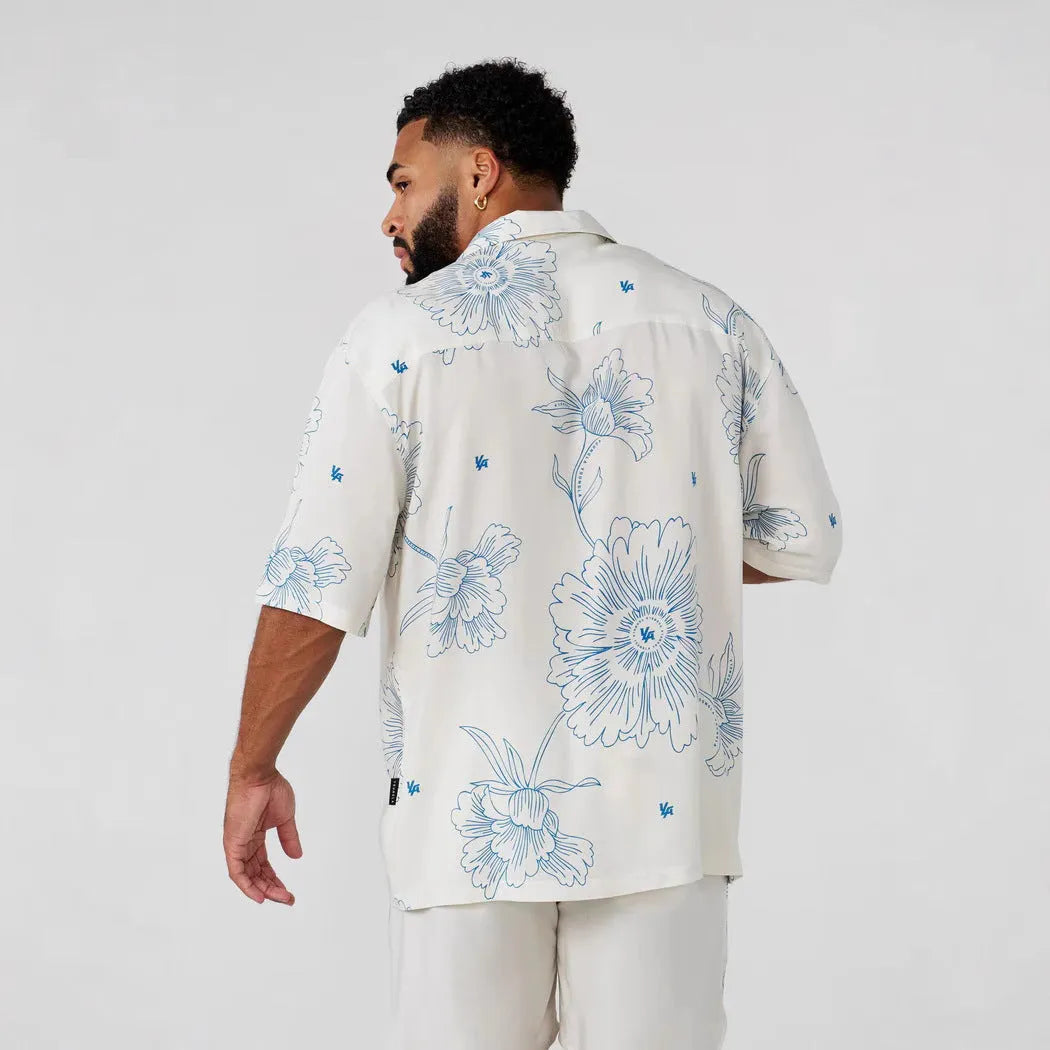 A man's loose-fitting, short-sleeve printed cardigan in a light colour for summer.