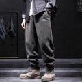 Grey men's sweatpants with ankle ties and a straight leg cut on a neutral background.