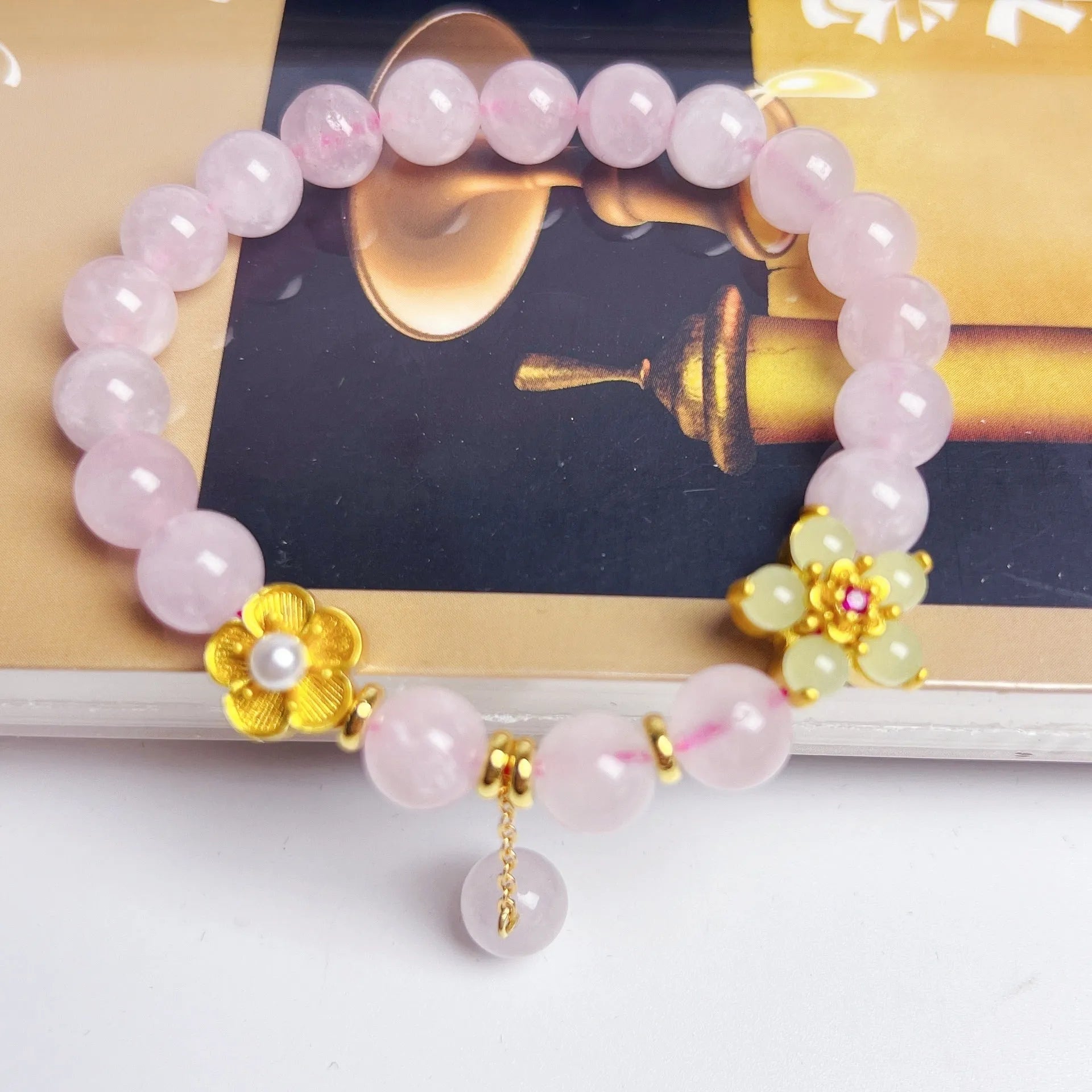 Pink crystal peach blossom bracelet with adjustable sliding knot closure on wrist