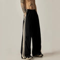 Black wide-leg men's climbing trousers with a high waist on a neutral background.