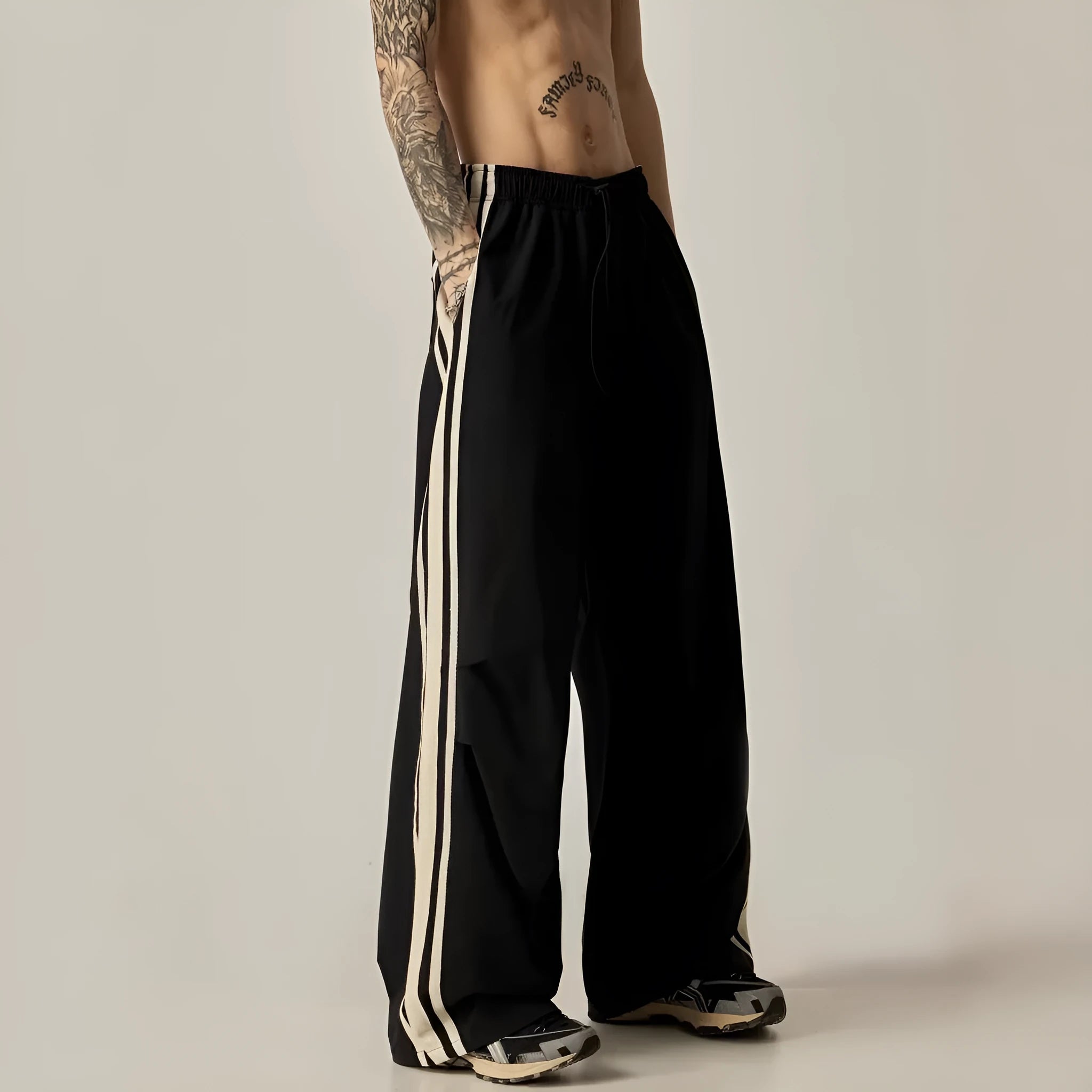 Black wide-leg men's climbing trousers with a high waist on a neutral background.