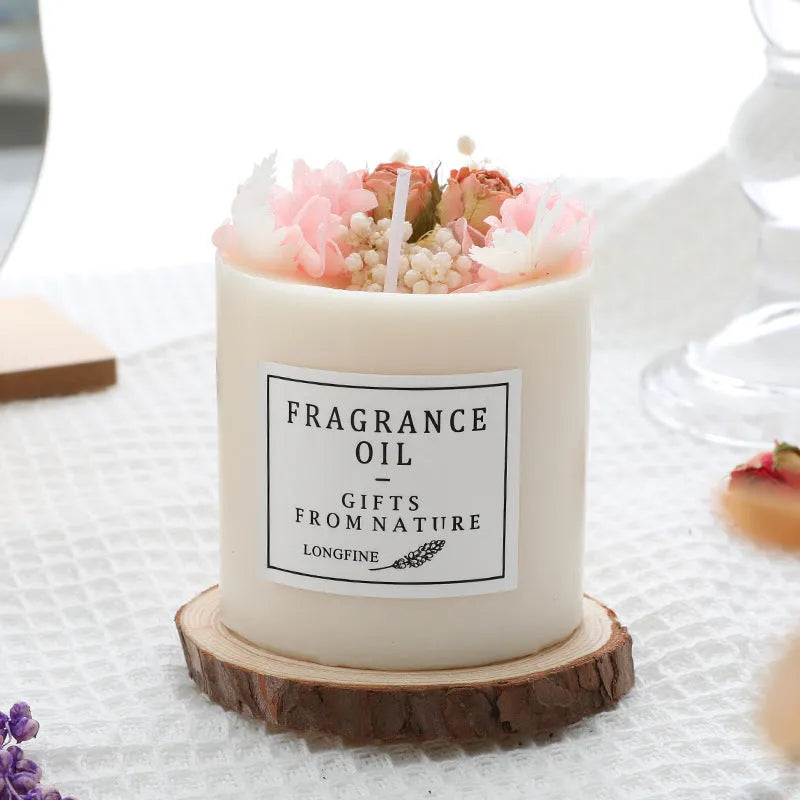 Decorative aromatherapy candle with dried flowers on a wood chip base, available in multiple scents.