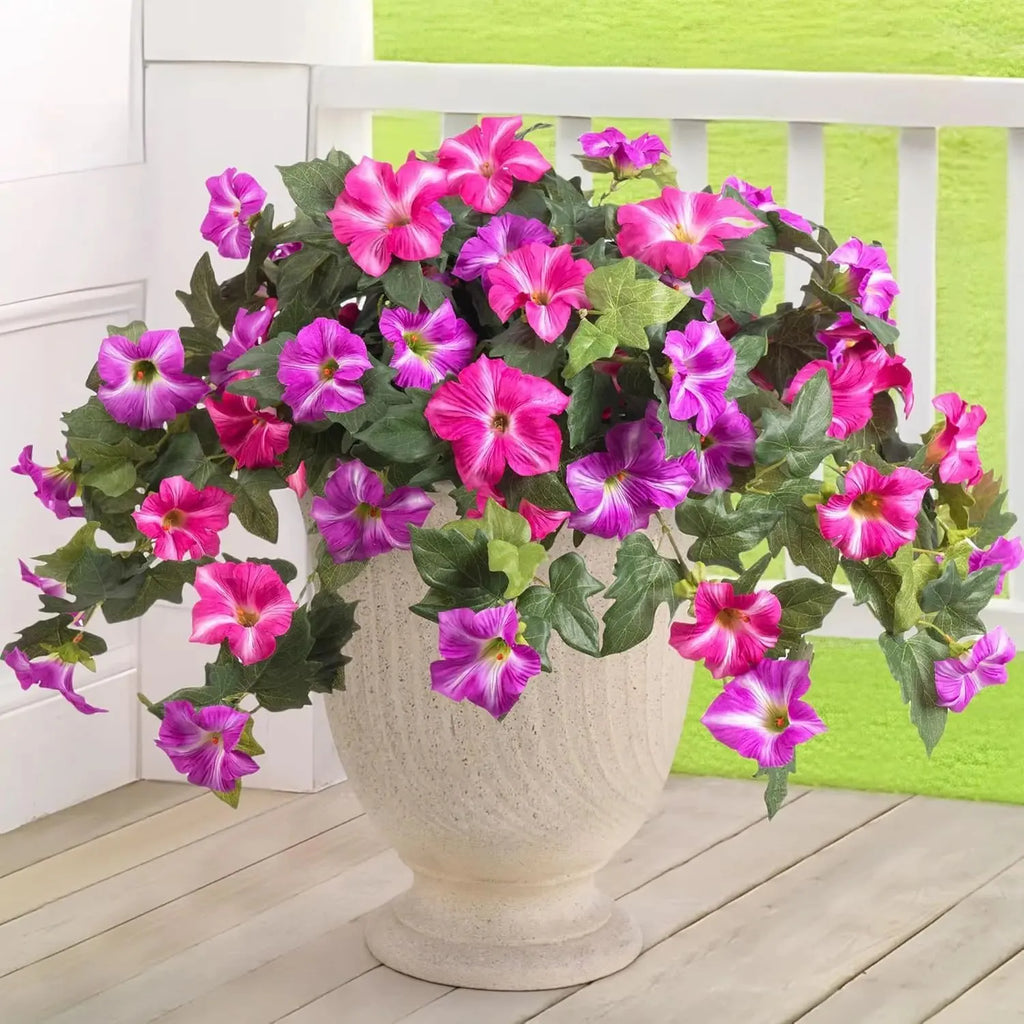 Purple plastic garden container with 12 forks holding red artificial silk flowers on a patio.