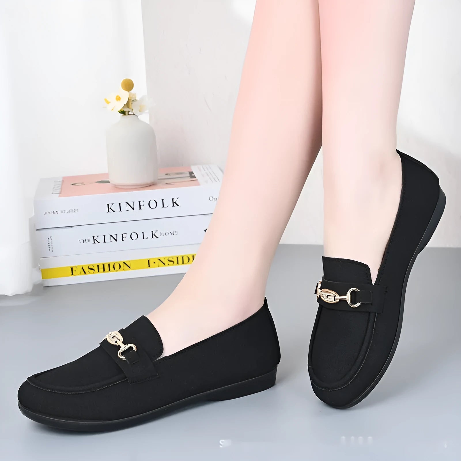 Women's black matte slip-on casual shoes with a round toe and soft rubber sole on a flat surface.