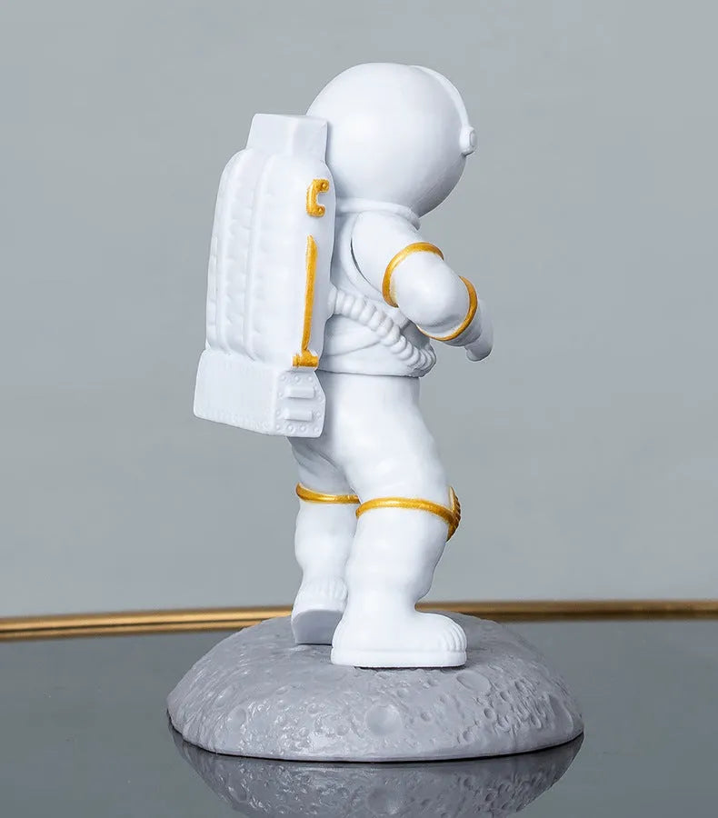Astronaut decoration spaceman plastic mobile phone holder in blue, gold, and silver colours for lazy binge-watching