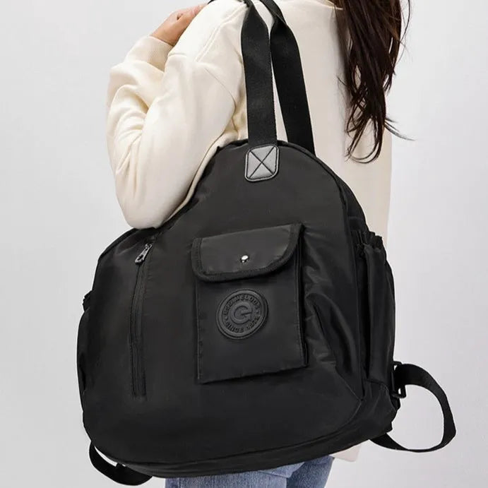 Large black nylon outdoor backpack with a front sandwich pocket, shown next to a khaki version.