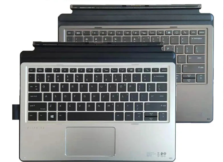 Elite X2 thin portable keyboard with PS/2 cable and wireless dongle on a wooden desk next to a tablet.