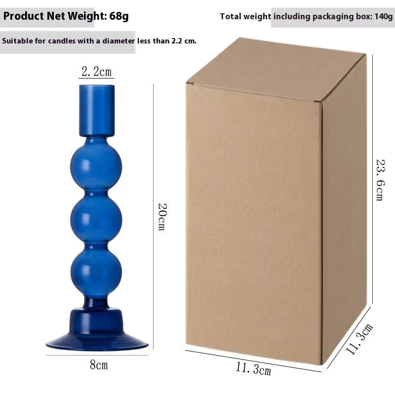 Transparent borosilicate glass candle holder in Three Ball Mott design, available in brown, blue, pink, green