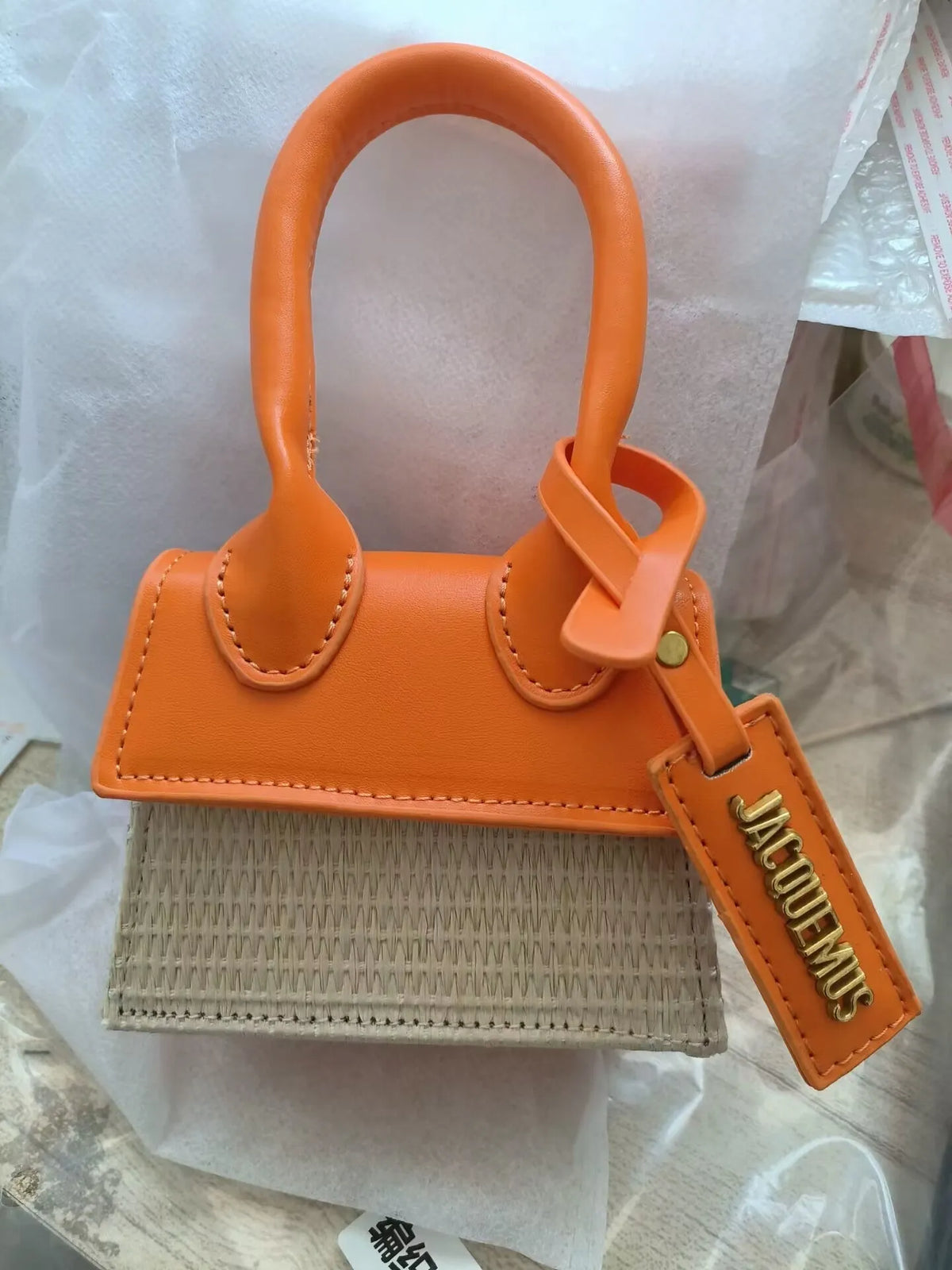 Women's woven PU crossbody bag in white, black or orange with single strap, 12cm wide, 10cm high and 6cm thick