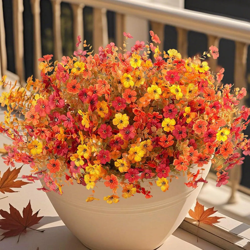 Artificial silk flower bouquet in autumn red, yellow, and orange colours for home or wedding decoration.
