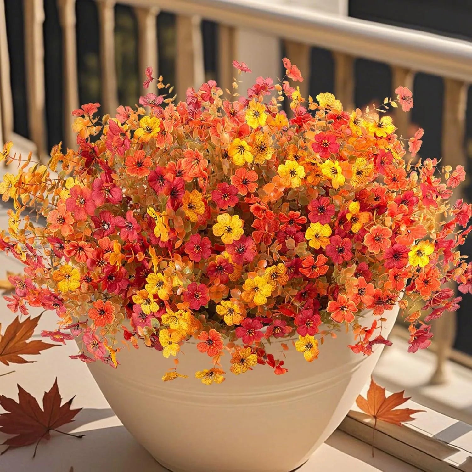 Artificial silk flower bouquet in autumn red, yellow, and orange colours for home or wedding decoration.