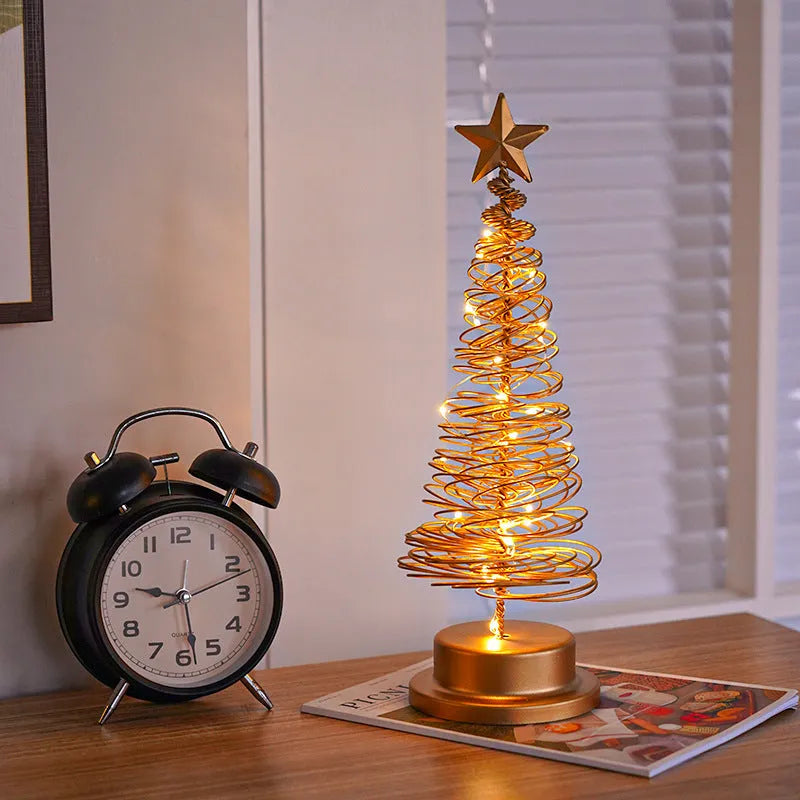 33cm wrought iron Christmas tree spiral light ornament with warm white LED illumination on table