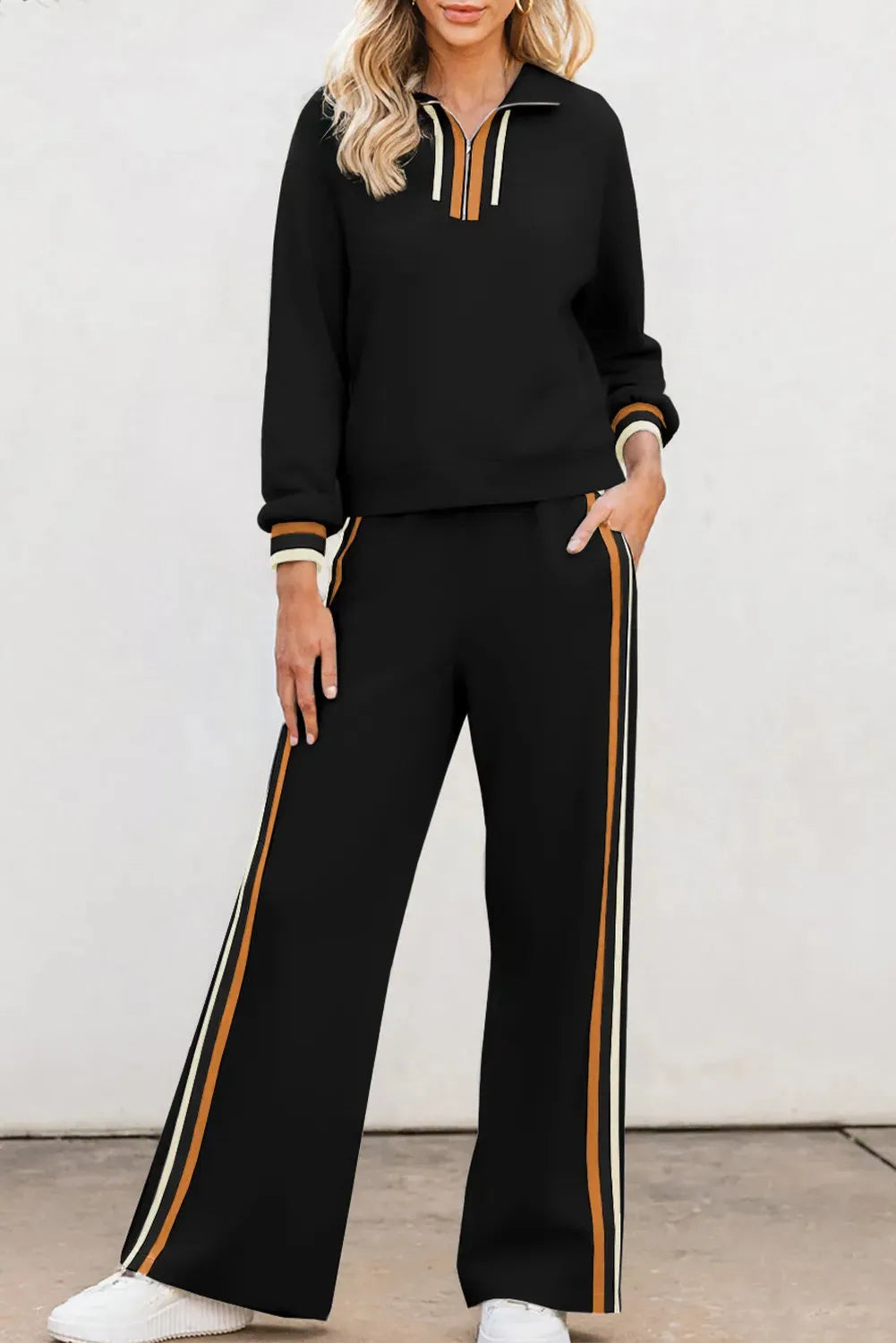 Black striped patchwork quarter zip pullover and loose trousers set on a model