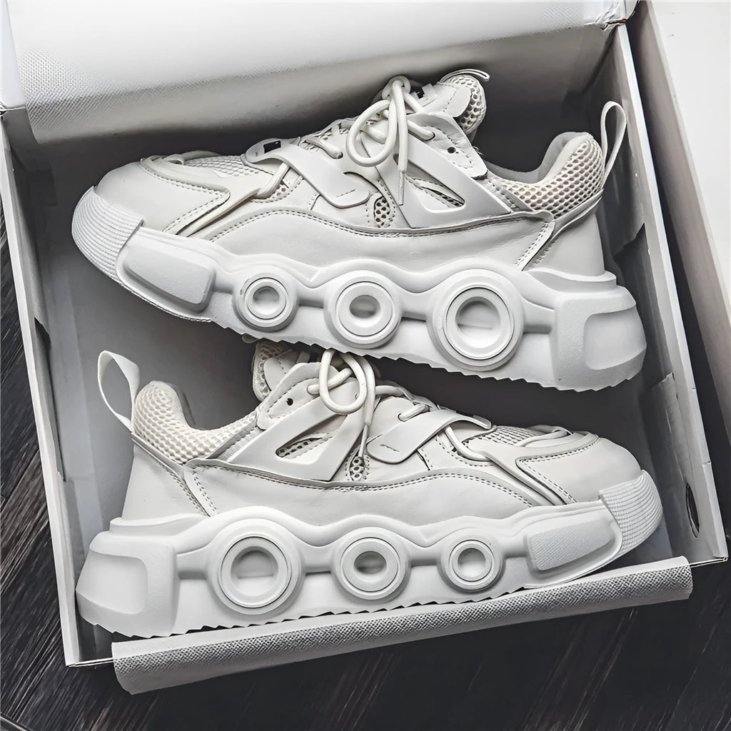 Men's low-top casual sneaker in grey with mesh upper, thick rubber sole, and round toe.