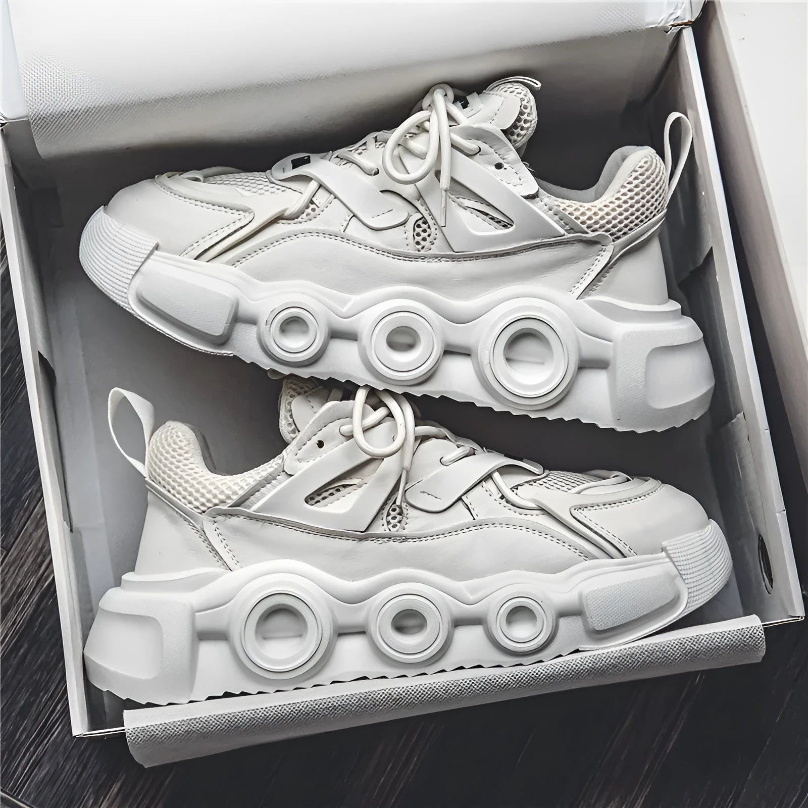 Men's low-top casual sneaker in grey with mesh upper, thick rubber sole, and round toe.