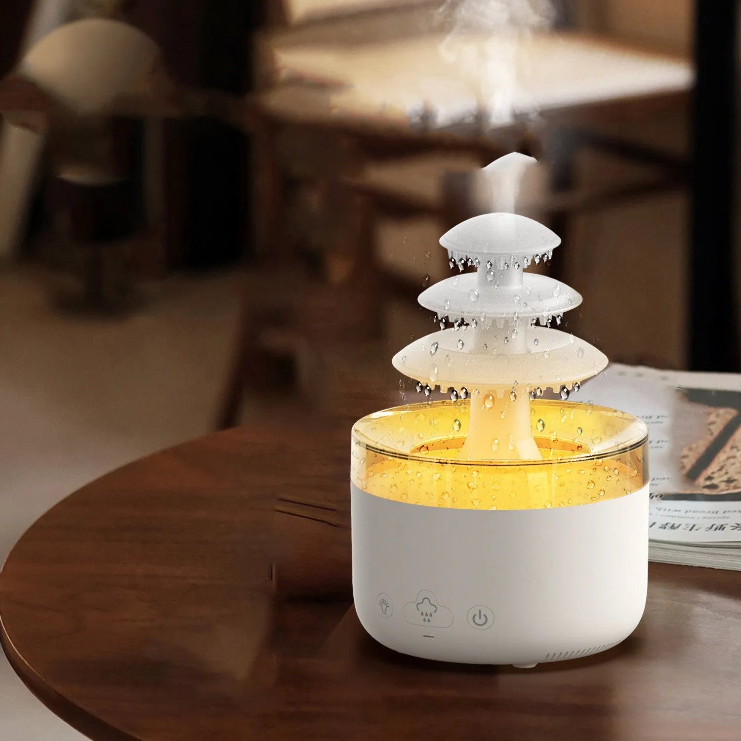 White Cloud Rain air humidifier and essential oil diffuser with colourful LED lights on a wooden table.