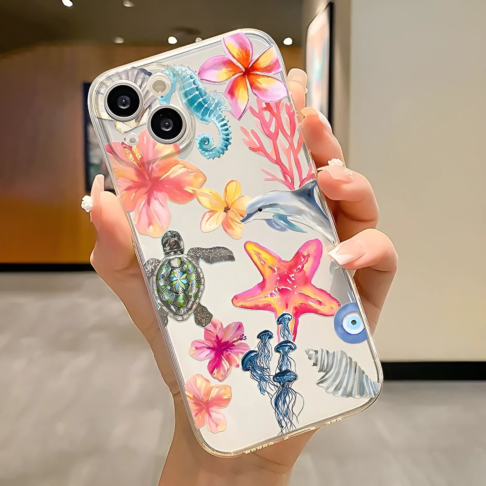 Clear TPU iPhone case with painted dolphin, turtle, plant, and shell design for anti-fall protection.