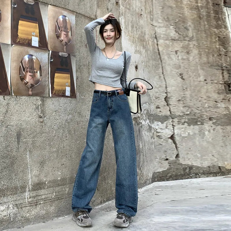 Women's retro blue straight-leg jeans with a high waist on a hanger.