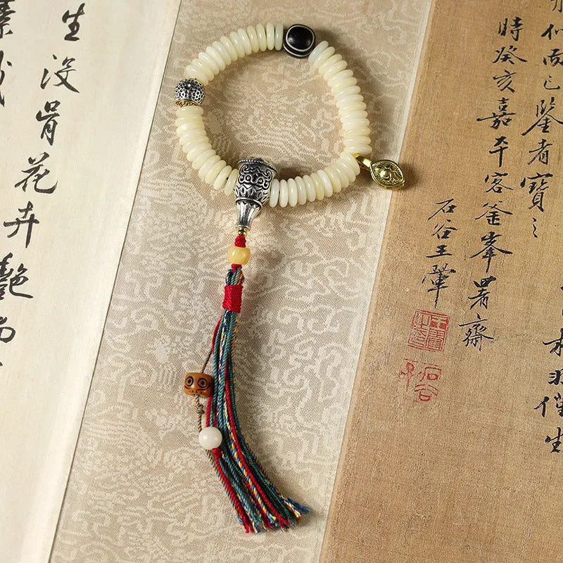 Close-up of a White Bodhi seed bracelet or handheld strand showing 3x10mm natural beads.