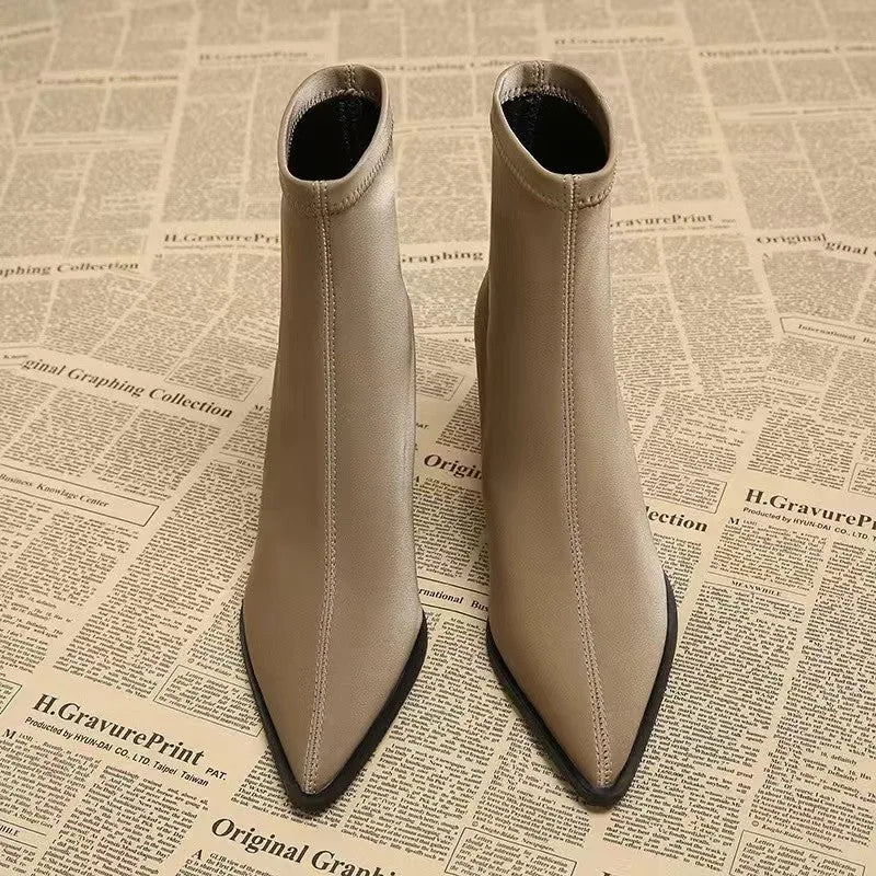Women's khaki pointed toe Martin boots with a wedge heel on a white background.