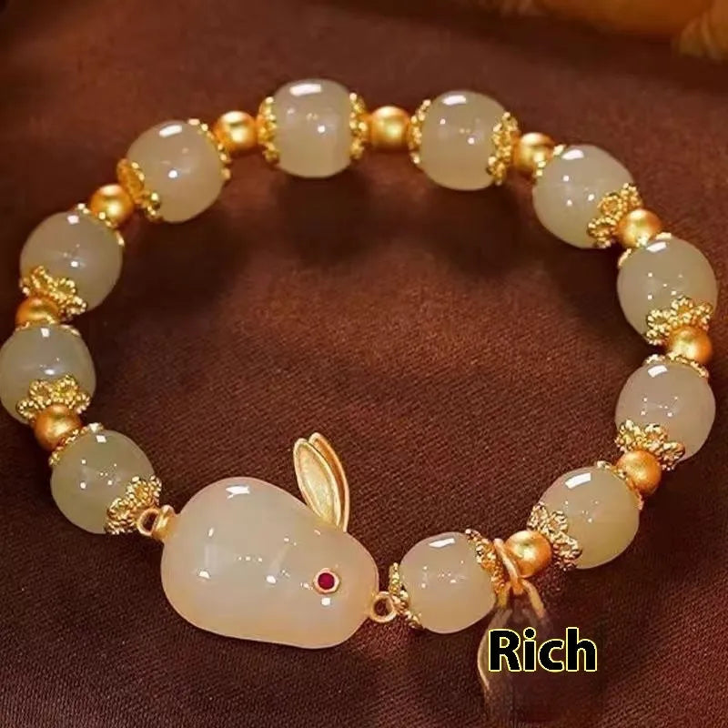 Green electroplated jade hare bracelet for women with Chinese style and lily design elements.