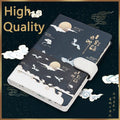 A5 wire-bound retro notebook open showing full-colour vintage illustrations, with a pen.